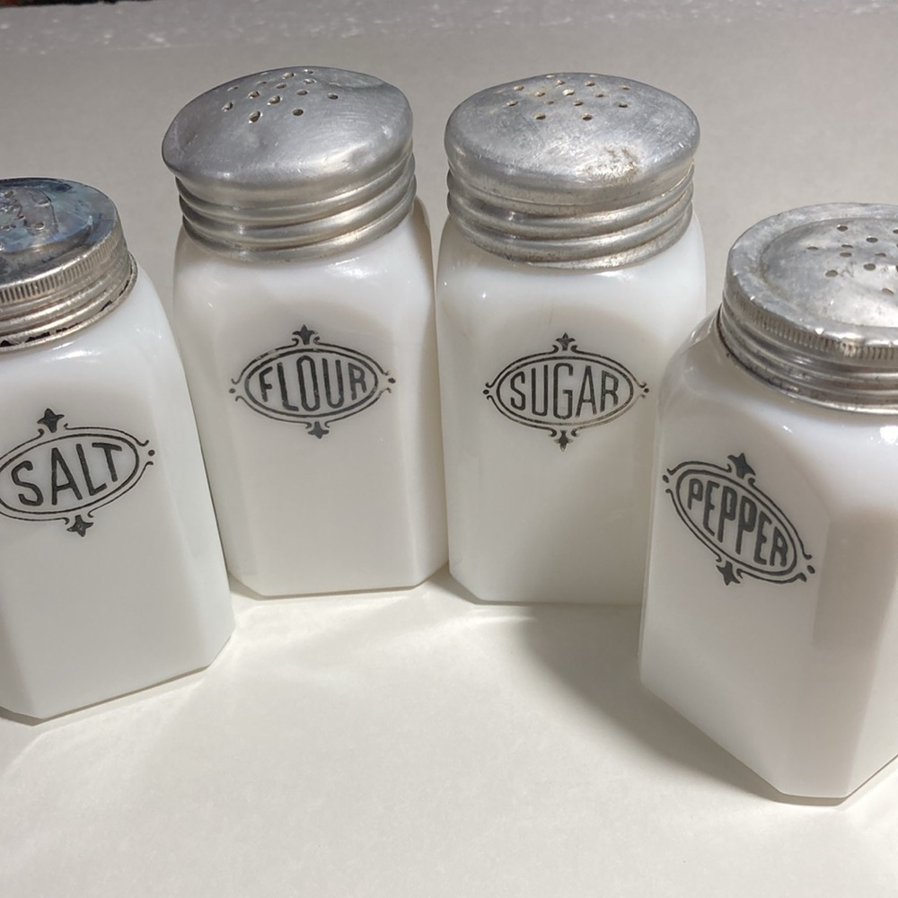 VINTAGE HAZEL SET OF FOUR ATLAS MILK GLASS BLACK BADGE RANGE SHAKERS